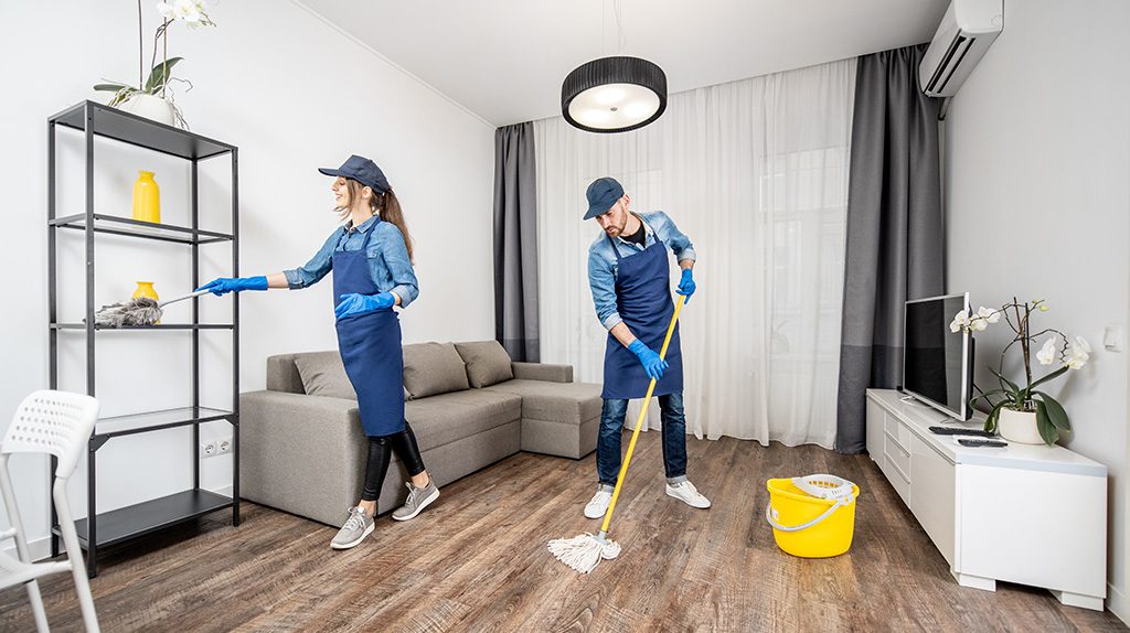 Cleaning team tidying a living room